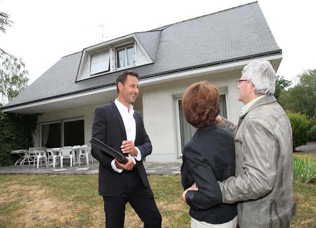 Real-estate agent with senior couple buying new house
